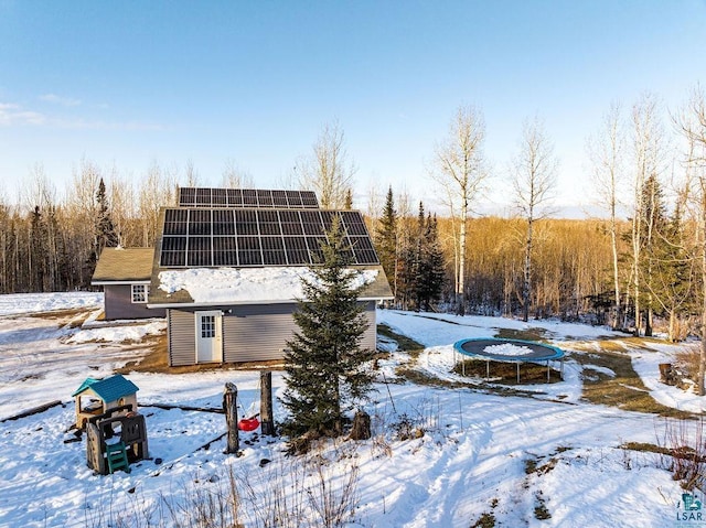 exterior space featuring a trampoline and solar panels