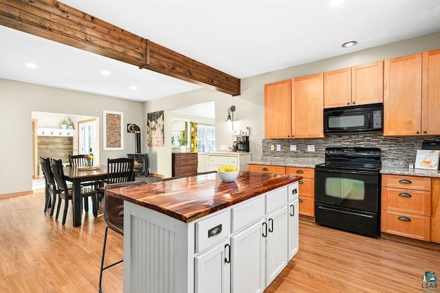 kitchen featuring a center island, black appliances, white cabinetry, decorative backsplash, and beam ceiling