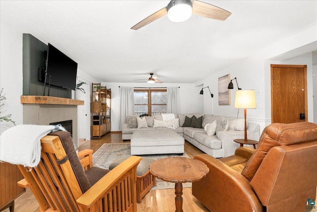 living room with ceiling fan and light hardwood / wood-style floors