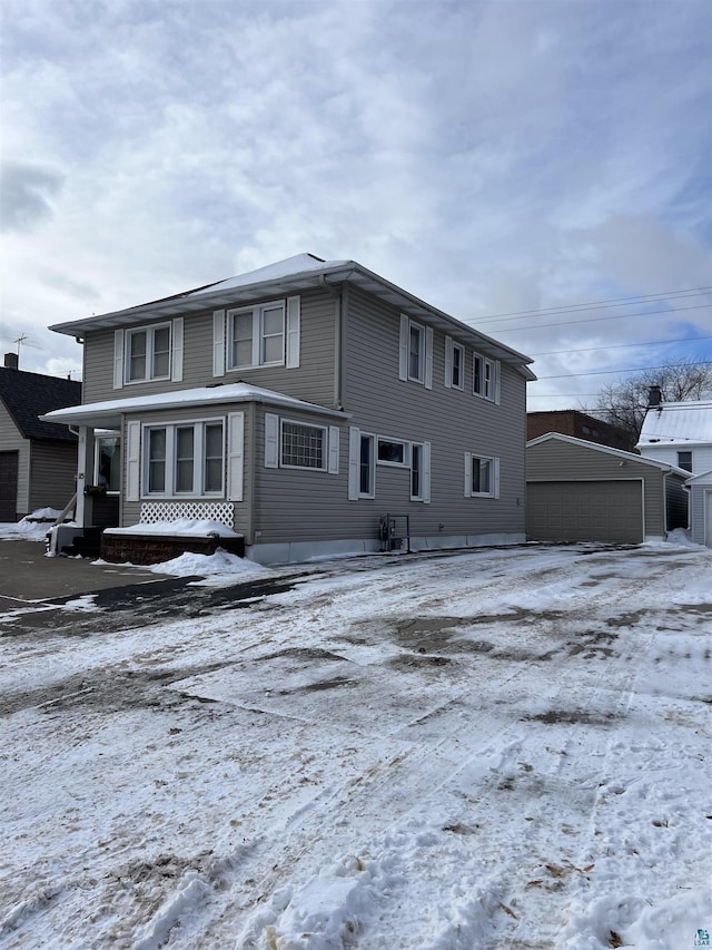 exterior space featuring a garage and an outbuilding