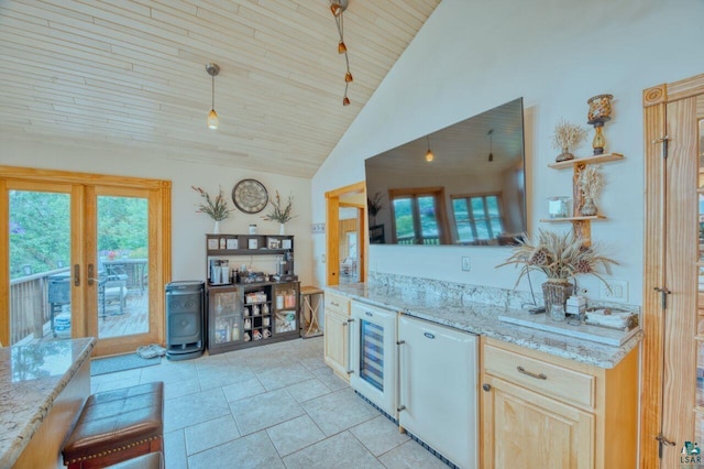 kitchen with french doors, light stone countertops, and beverage cooler