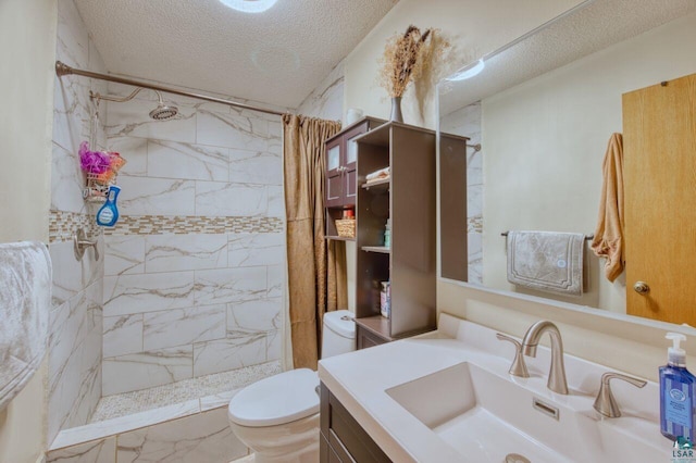 bathroom featuring toilet, vanity, a textured ceiling, and curtained shower