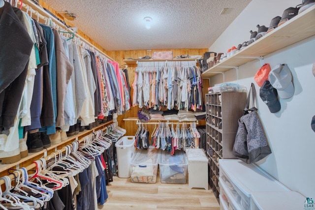 spacious closet with light hardwood / wood-style flooring