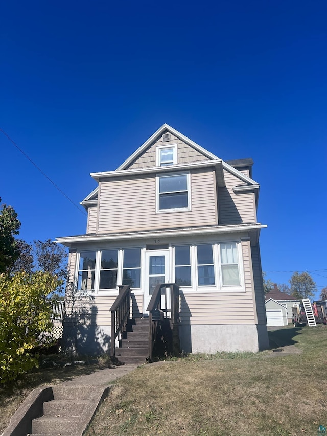 view of front of property featuring a garage and a front yard