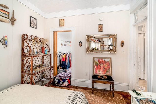 bedroom featuring a closet and crown molding