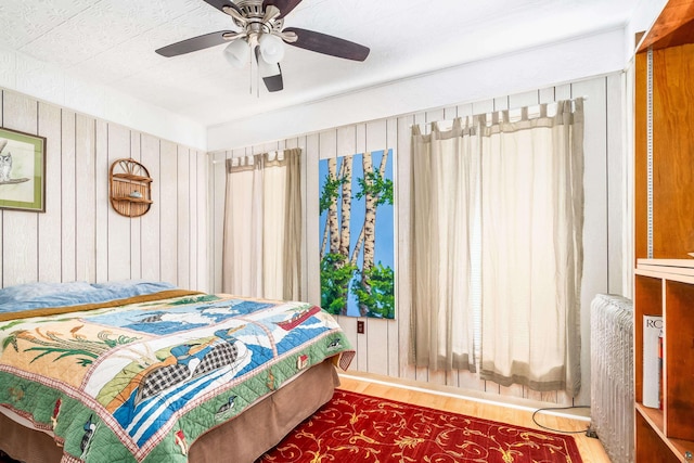 bedroom with ceiling fan and hardwood / wood-style flooring