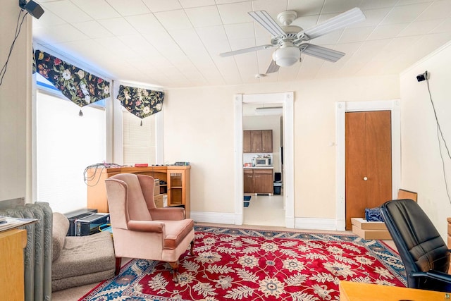 sitting room featuring ceiling fan and a healthy amount of sunlight