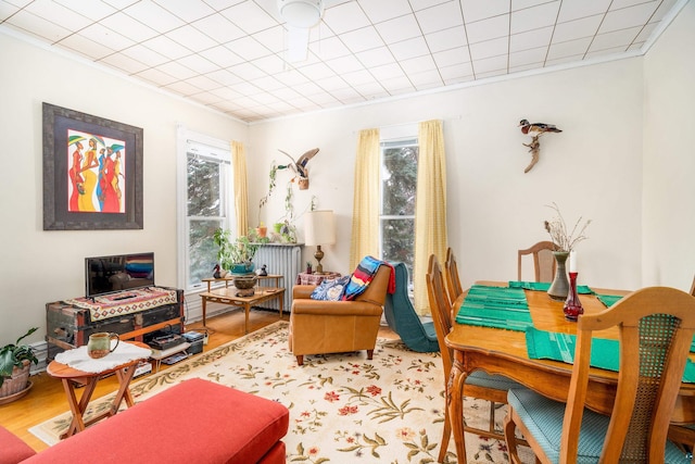 living area with ornamental molding and hardwood / wood-style floors