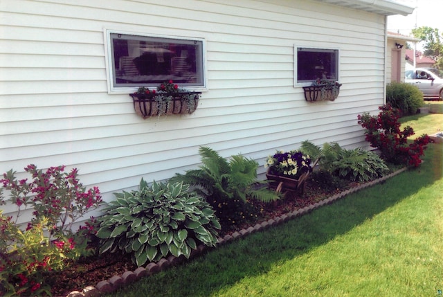 view of property exterior with a yard