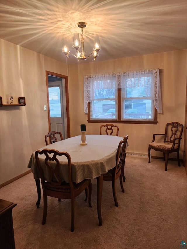 dining area with a chandelier and carpet