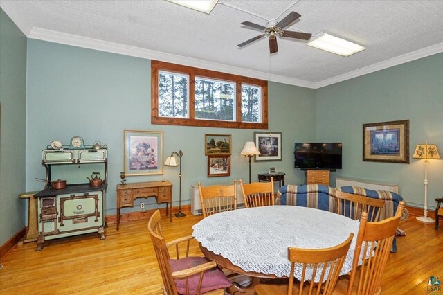 7596 Werner Rd, Virginia, MN 55720 - dining space with light hardwood / wood-style floors, a textured ceiling, ornamental molding, and ceiling fan
