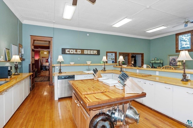 7596 Werner Rd, Virginia, MN 55720 - kitchen featuring white cabinetry, ornamental molding, and stainless steel dishwasher