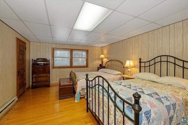 7596 Werner Rd, Virginia, MN 55720 - bedroom with a drop ceiling, a baseboard heating unit, and light wood-type flooring