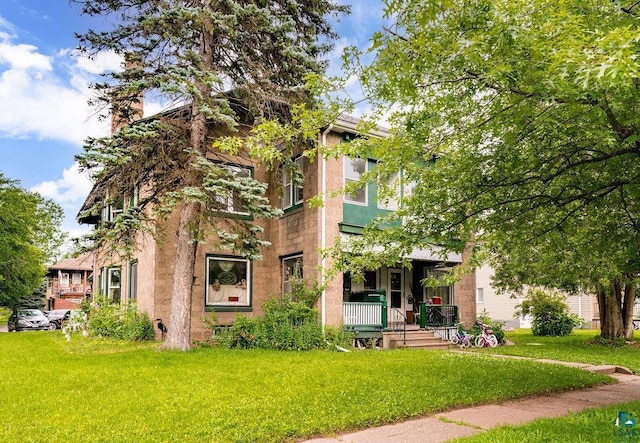 view of front of home featuring a front yard and a porch