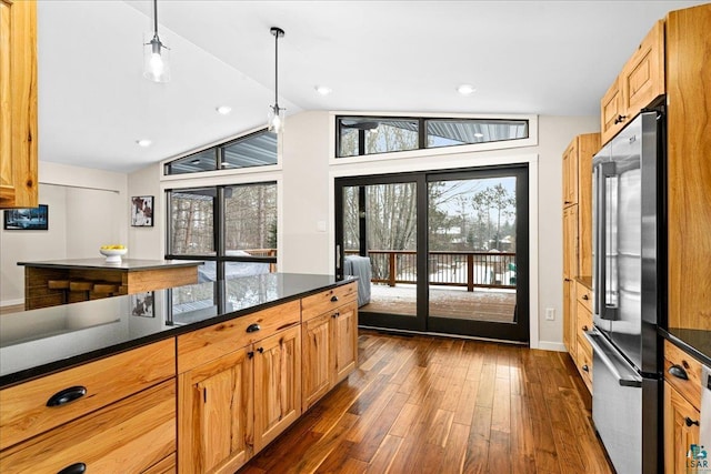 kitchen featuring lofted ceiling, dark wood-type flooring, decorative light fixtures, and high end refrigerator