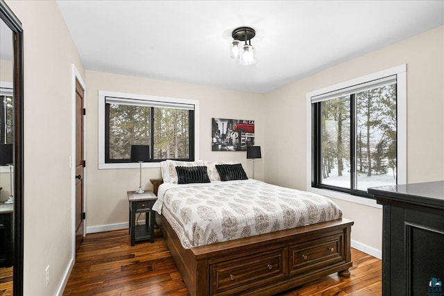 bedroom with dark hardwood / wood-style floors