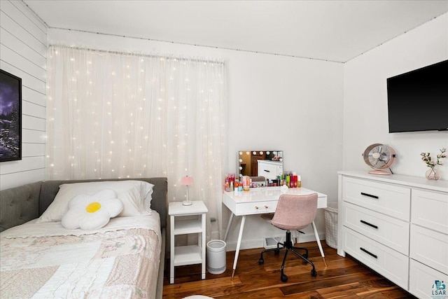 bedroom with dark hardwood / wood-style floors