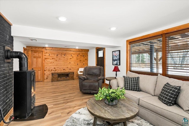 living room featuring a wood stove and light wood-type flooring