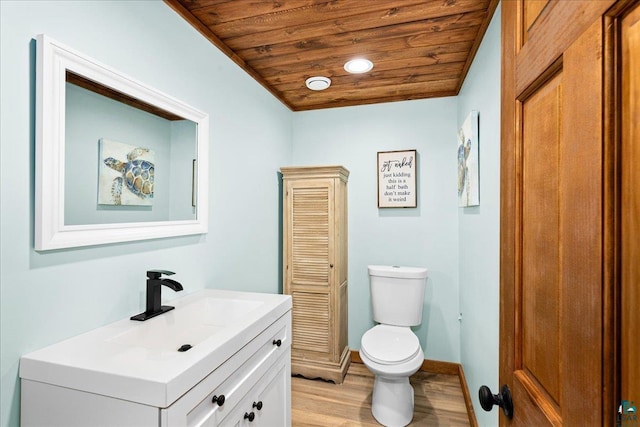 bathroom with wooden ceiling, hardwood / wood-style floors, toilet, and vanity