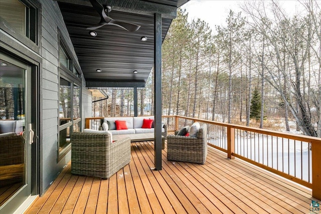 deck featuring ceiling fan and outdoor lounge area