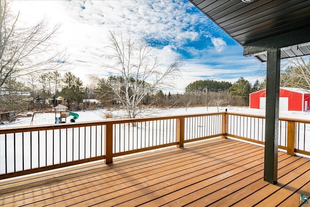 snow covered deck with a playground