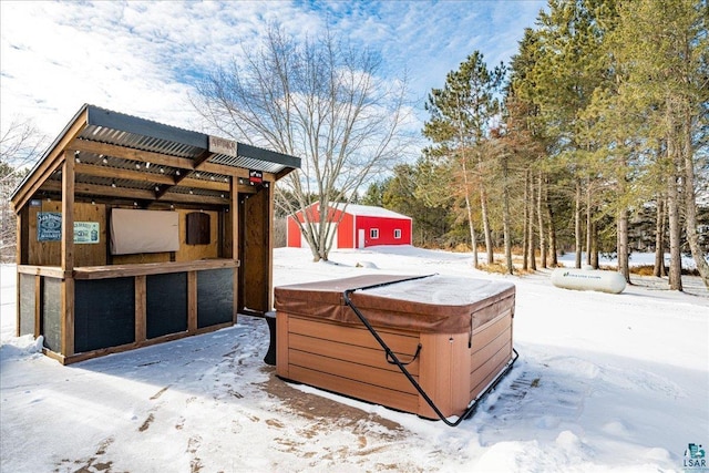 exterior space featuring a hot tub and an outdoor structure