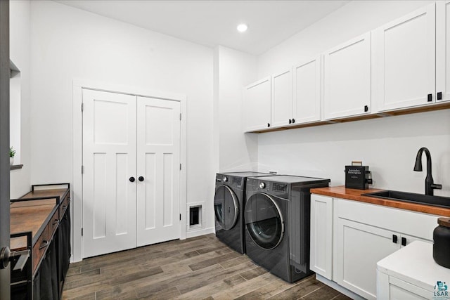 laundry area with sink, separate washer and dryer, and cabinets