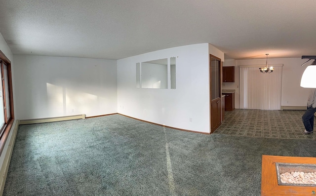 unfurnished living room with dark colored carpet, a baseboard heating unit, and a textured ceiling