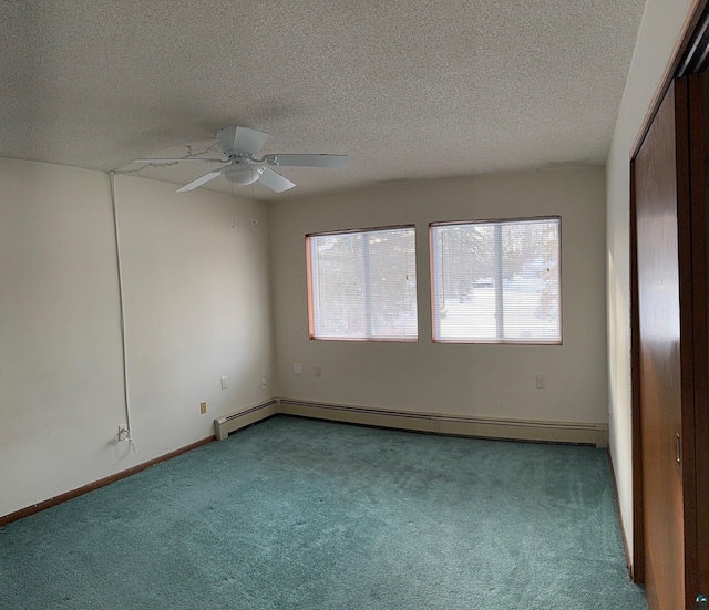 spare room with a baseboard heating unit, ceiling fan, carpet flooring, and a textured ceiling