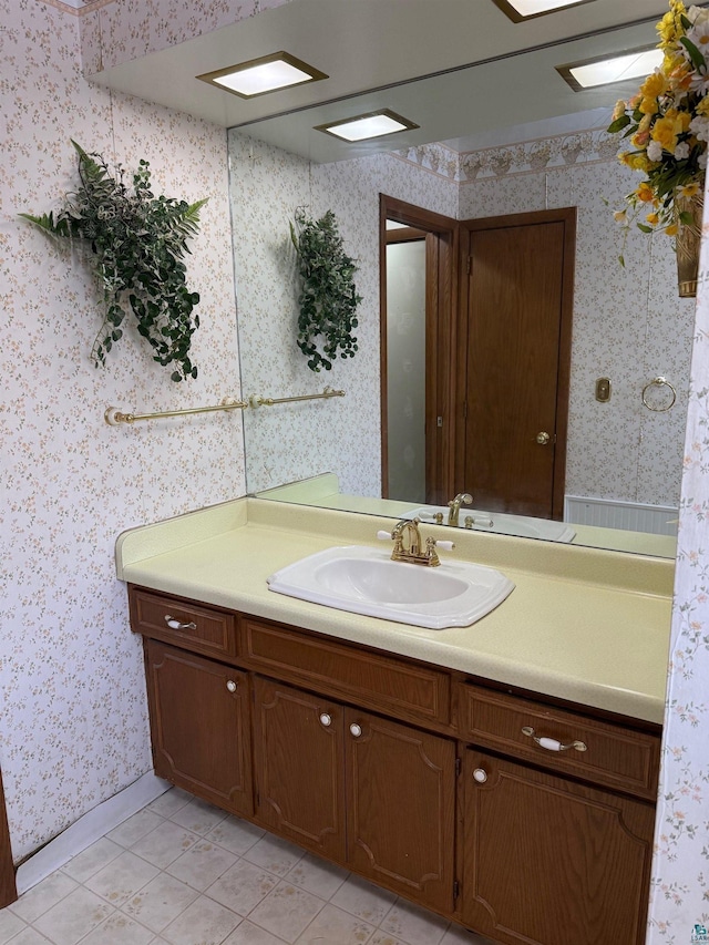 bathroom featuring tile patterned flooring and vanity