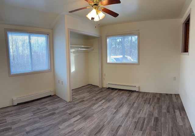 unfurnished bedroom with ceiling fan, hardwood / wood-style floors, and a baseboard heating unit