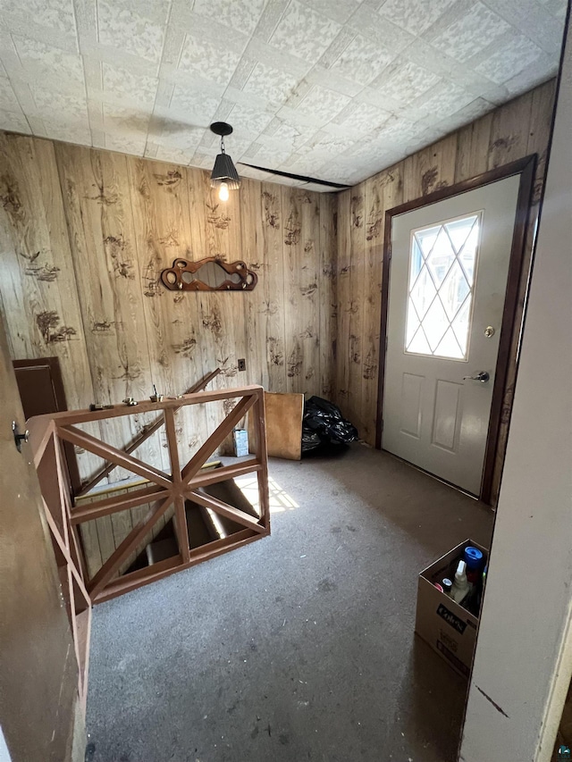 foyer featuring wood walls