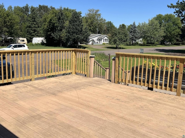 wooden terrace with a yard