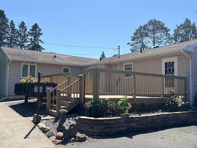 back of house featuring a wooden deck