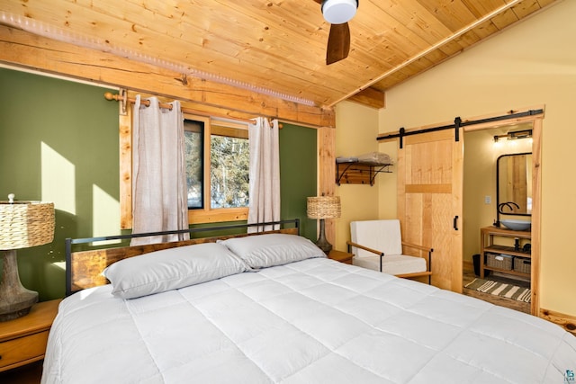 bedroom featuring wood ceiling, vaulted ceiling, a barn door, and ceiling fan