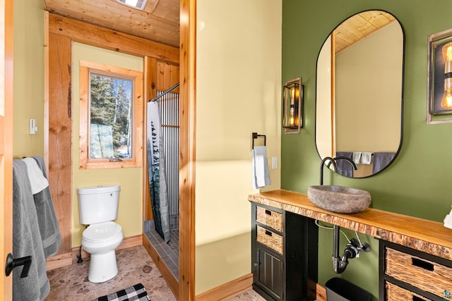 bathroom with curtained shower, vanity, toilet, wooden ceiling, and tile patterned floors