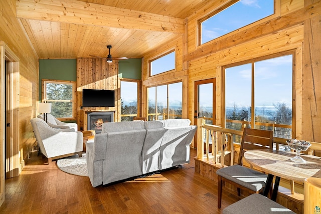 living room featuring hardwood / wood-style flooring, a fireplace, and wooden ceiling