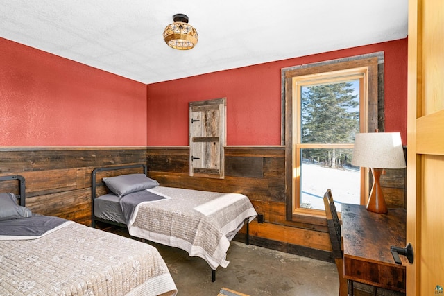 bedroom featuring wooden walls