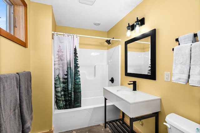 full bathroom featuring sink, shower / bath combination with curtain, and toilet