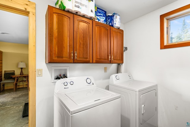 laundry area with cabinets and washer and clothes dryer