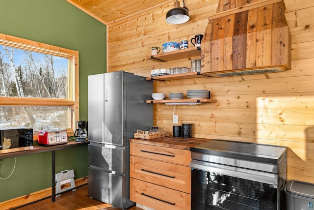 kitchen featuring dark hardwood / wood-style flooring, wooden walls, wooden ceiling, and appliances with stainless steel finishes