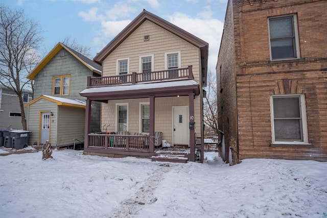 view of front property with a porch and a balcony