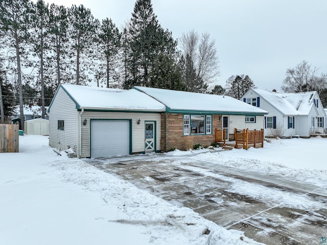 ranch-style home featuring a shed and a garage