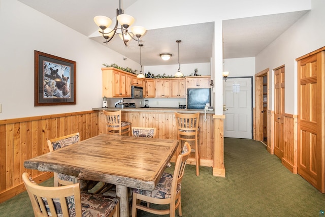 carpeted dining space featuring lofted ceiling, a notable chandelier, and wooden walls