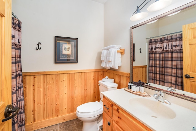 bathroom with vanity, tile patterned floors, and toilet