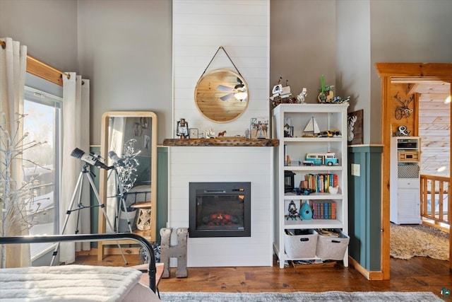 bedroom featuring dark hardwood / wood-style flooring and wood walls