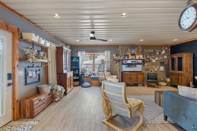 living room featuring ceiling fan and light hardwood / wood-style floors