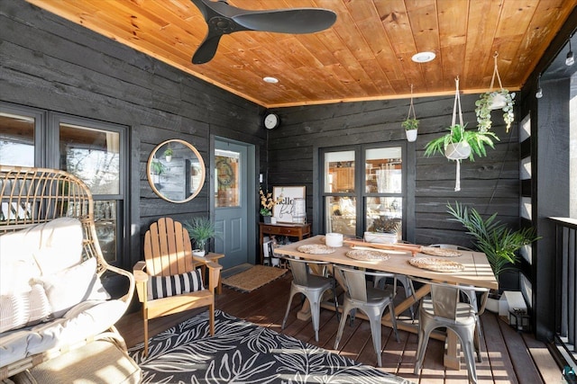 sunroom featuring lofted ceiling, wooden ceiling, and ceiling fan