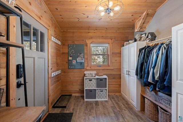 interior space with vaulted ceiling, hardwood / wood-style floors, wood walls, a notable chandelier, and wooden ceiling