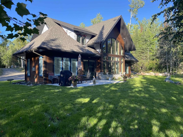 view of home's exterior with a patio area and a lawn